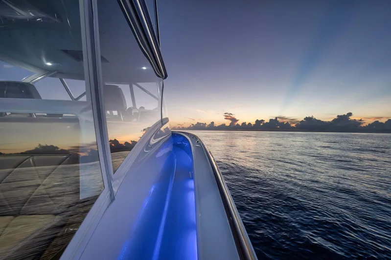 Karma Yacht Photos Pics 2019 Winter Custom Yachts 46 Walkaround at sunset, reflecting on calm ocean waters.