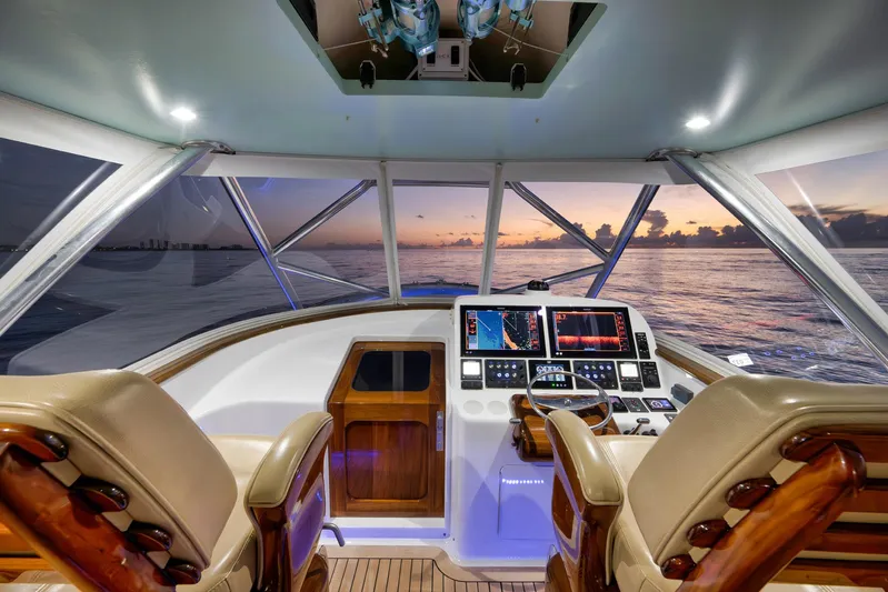 Karma Yacht Photos Pics 2019 Winter Custom Yachts 46 Walkaround helm with sunset ocean view, featuring advanced navigation displays.