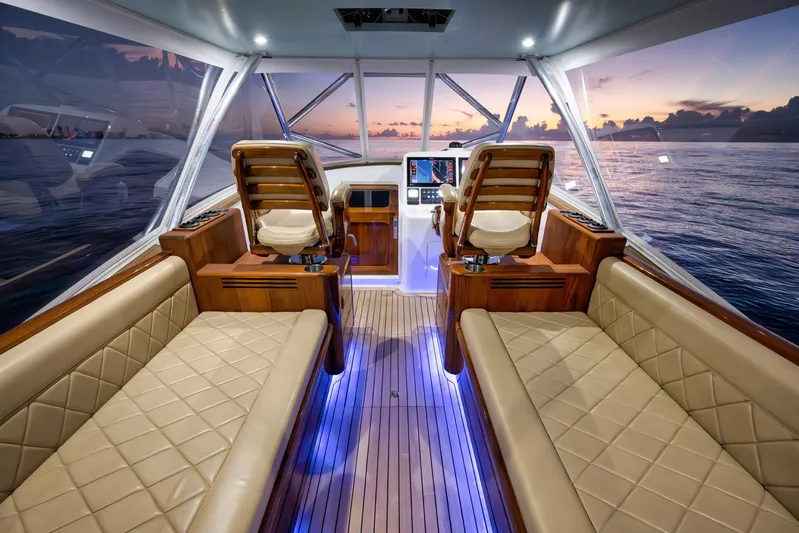 Karma Yacht Photos Pics Luxurious interior of 2019 Winter Custom Yachts 46 Walkaround at sunset, featuring plush seating and wood accents.