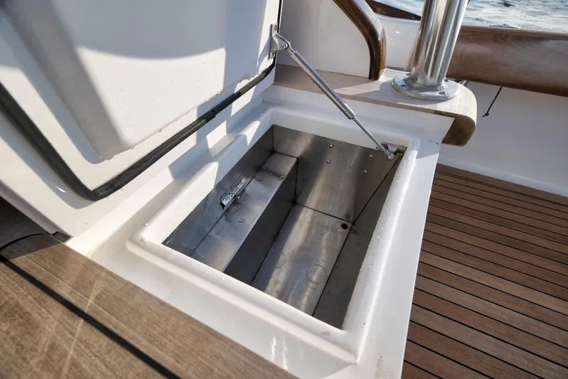 Karma Yacht Photos Pics Open storage compartment on 2019 Winter Custom Yachts 46 Walkaround, featuring teak decking.