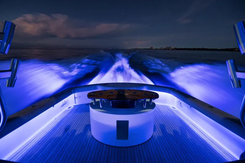 Karma Yacht Photos Pics 2019 Winter Custom Yachts 46 Walkaround cruising at night with vibrant blue lighting.