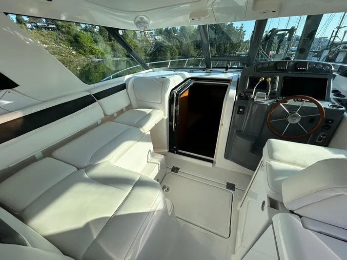  Yacht Photos Pics 2005 Tiara Yachts 3600 Sovran interior with white seating and helm station.