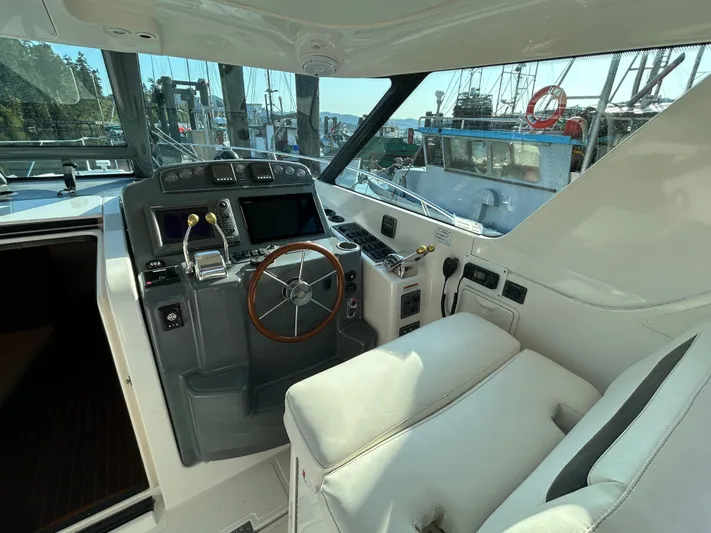  Yacht Photos Pics 2005 Tiara Yachts 3600 Sovran helm with steering wheel and navigation controls.