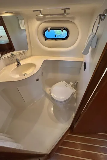  Yacht Photos Pics 2005 Tiara Yachts 3600 Sovran bathroom with sink, toilet, and porthole window.
