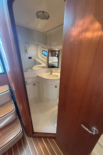  Yacht Photos Pics 2005 Tiara Yachts 3600 Sovran bathroom with wooden door and modern fixtures.