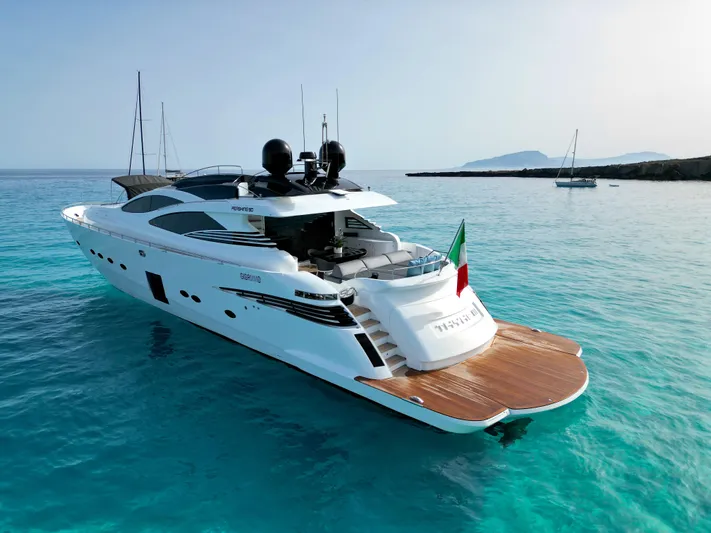 Thyke III Yacht Photos Pics Luxurious 2008 Pershing 90 yacht on clear turquoise waters, featuring sleek design and Italian flag.