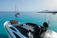 Luxurious 2008 Pershing 90 yacht on turquoise waters with sailboats in the background.