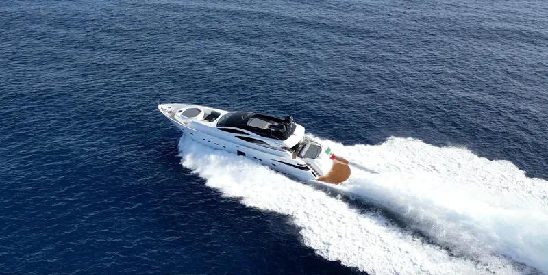 Thyke III Yacht Photos Pics Luxury 2008 Pershing 90 yacht cruising on open sea, aerial view.