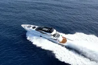 Luxury 2008 Pershing 90 yacht cruising on open sea, aerial view.