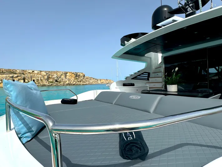 Thyke III Yacht Photos Pics Luxurious 2008 Pershing 90 yacht deck with cushions, towel, and ocean view.