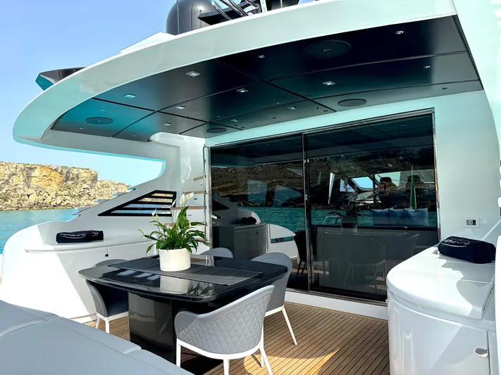 Thyke III Yacht Photos Pics Luxurious 2008 Pershing 90 yacht deck with modern seating and ocean view.