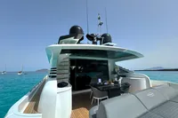 2008 Pershing 90 yacht on turquoise water, featuring sleek design and outdoor seating area.