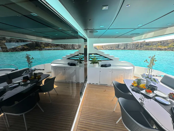 Thyke III Yacht Photos Pics Luxurious 2008 Pershing 90 yacht deck with elegant dining area and stunning ocean view.