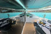 Luxurious 2008 Pershing 90 yacht deck with elegant dining area and stunning ocean view.