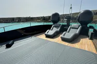Luxurious 2008 Pershing 90 yacht deck with sun loungers and scenic ocean view.
