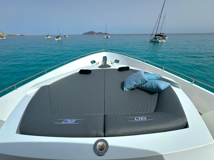 Thyke III Yacht Photos Pics 2008 Pershing 90 yacht with sunbathing deck, anchored in clear blue waters.