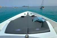 2008 Pershing 90 yacht with sunbathing deck, anchored in clear blue waters.
