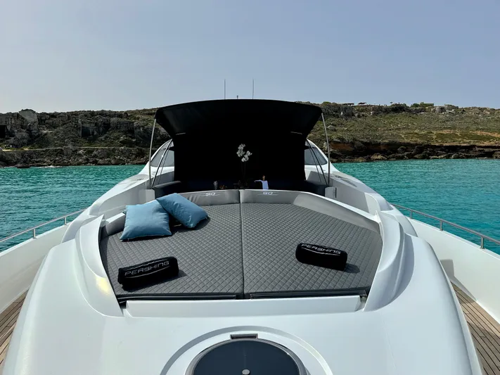 Thyke III Yacht Photos Pics 2008 Pershing 90 yacht with sunbathing deck, cushions, and scenic ocean view.