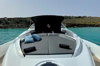 2008 Pershing 90 yacht with sunbathing deck, cushions, and scenic ocean view.