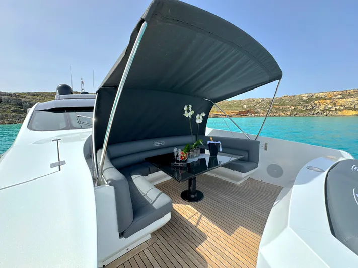 Thyke III Yacht Photos Pics Luxurious 2008 Pershing 90 yacht with shaded seating area and elegant table on deck.