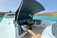 Luxurious 2008 Pershing 90 yacht with shaded seating area and elegant table on deck.