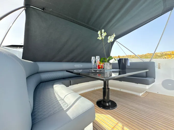 Thyke III Yacht Photos Pics Luxurious seating area on a 2008 Pershing 90 yacht with elegant table and decor.