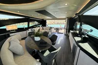 Luxurious interior of a 2008 Pershing 90 yacht with modern furnishings and scenic ocean view.
