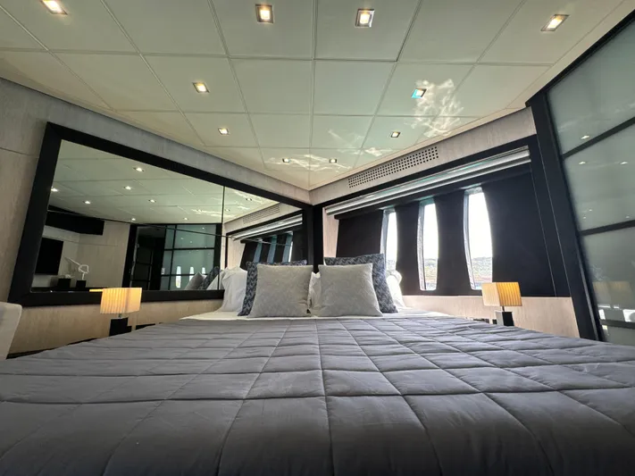 Thyke III Yacht Photos Pics Luxurious bedroom interior on 2008 Pershing 90 yacht with modern decor and ambient lighting.