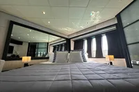 Luxurious bedroom interior on 2008 Pershing 90 yacht with modern decor and ambient lighting.