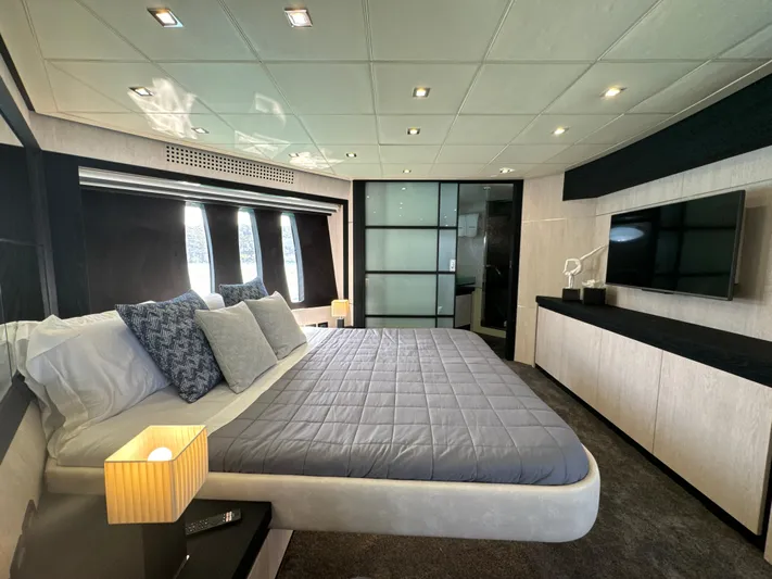 Thyke III Yacht Photos Pics Luxurious bedroom interior on a 2008 Pershing 90 yacht, featuring modern design and elegant furnishings.