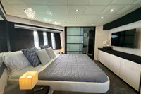 Luxurious bedroom interior on a 2008 Pershing 90 yacht, featuring modern design and elegant furnishings.