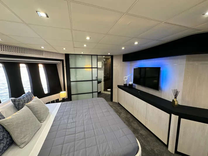 Thyke III Yacht Photos Pics Luxurious bedroom interior of 2008 Pershing 90 yacht with modern decor and ambient lighting.