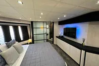 Luxurious bedroom interior of 2008 Pershing 90 yacht with modern decor and ambient lighting.