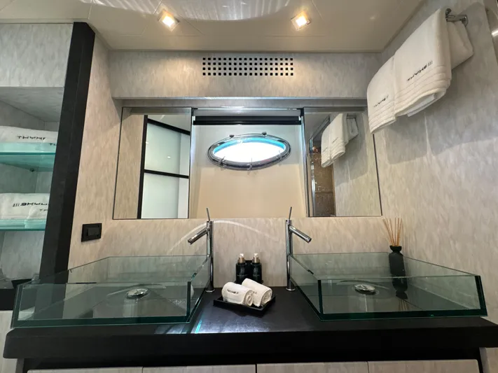 Thyke III Yacht Photos Pics Luxurious bathroom with dual glass sinks in a 2008 Pershing 90 yacht.