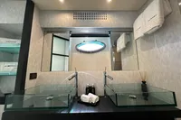 Luxurious bathroom with dual glass sinks in a 2008 Pershing 90 yacht.