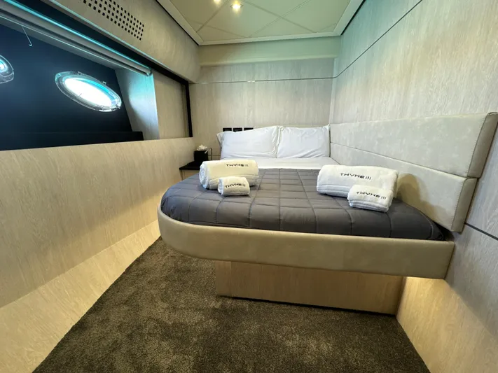 Thyke III Yacht Photos Pics Luxurious bedroom interior of a 2008 Pershing 90 yacht with modern design and cozy bedding.