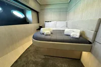 Luxurious bedroom interior of a 2008 Pershing 90 yacht with modern design and cozy bedding.