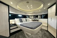 Luxurious bedroom interior of 2008 Pershing 90 yacht with modern design and ambient lighting.