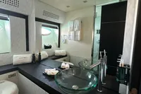 Luxurious bathroom in 2008 Pershing 90 yacht with modern glass sink and elegant decor.