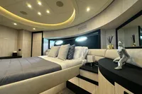 Luxurious bedroom interior of 2008 Pershing 90 yacht with modern decor and ambient lighting.