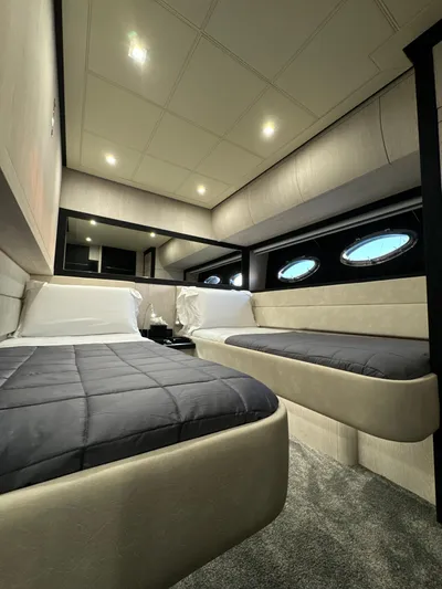 Thyke III Yacht Photos Pics Luxurious interior cabin of a 2008 Pershing 90 yacht with modern twin beds.