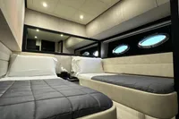 Luxurious interior cabin of a 2008 Pershing 90 yacht with modern twin beds.