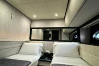 Luxurious twin cabin interior of 2008 Pershing 90 yacht with modern design and ambient lighting.