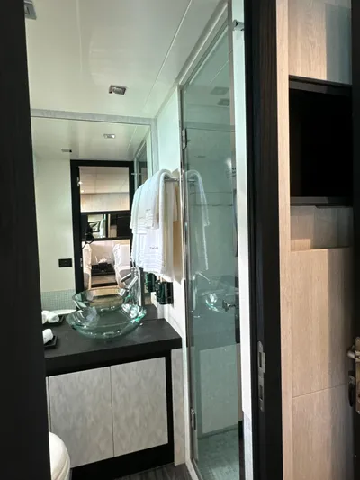 Thyke III Yacht Photos Pics Luxurious bathroom interior of a 2008 Pershing 90 yacht with modern glass sink.