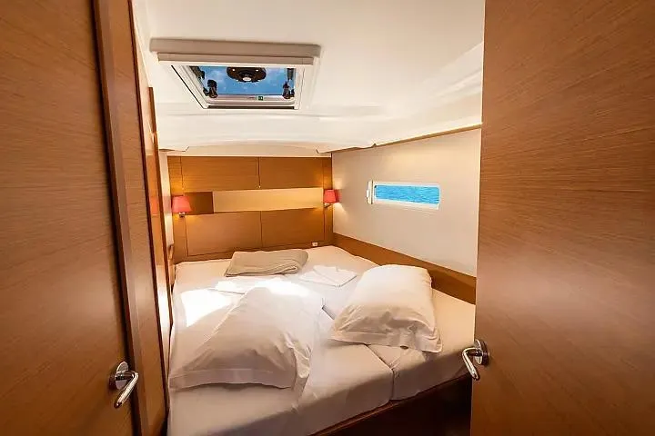  Yacht Photos Pics Luxurious cabin interior of 2021 Jeanneau Sun Odyssey 410 yacht with cozy bedding.