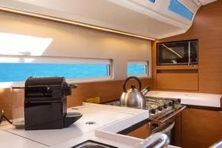  Yacht Photos Pics Modern kitchen interior of 2021 Jeanneau Sun Odyssey 410 yacht with ocean view.