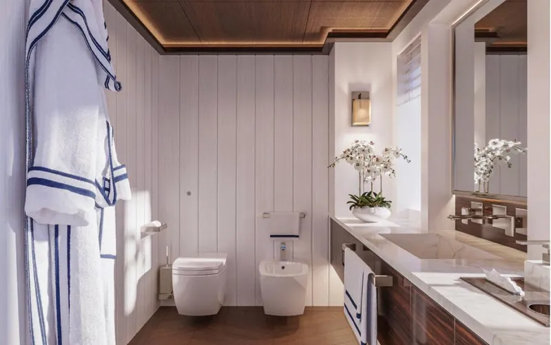  Yacht Photos Pics Luxurious modern bathroom with white paneling, elegant fixtures, and a plush robe, Wider 76, 2025.