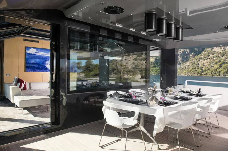 Sun Yacht Photos Pics Luxurious dining area on 2012 Arcadia Yachts 115, featuring elegant table setting and scenic views.