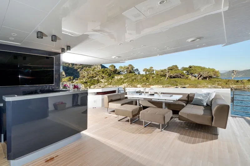 Sun Yacht Photos Pics Luxurious outdoor lounge on 2012 Arcadia Yachts 115, featuring modern seating and scenic views.