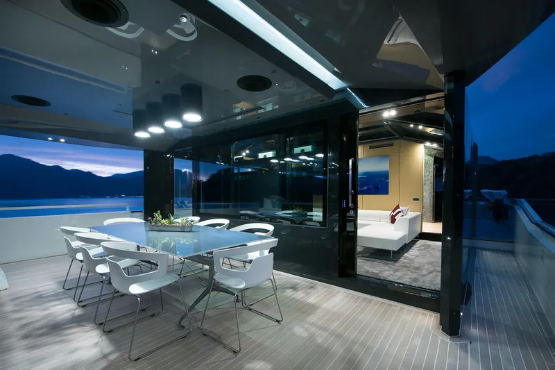 Sun Yacht Photos Pics Luxurious Arcadia Yachts 115, 2012 model, featuring elegant outdoor dining area at sunset.